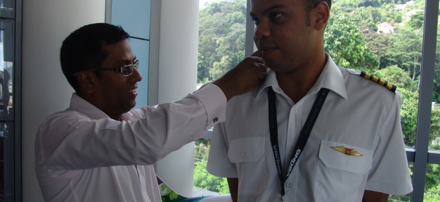 Air Seychelles’ Chief Executive Officer, Manoj Papa, fastens Captain Gabriel’s epaulettes